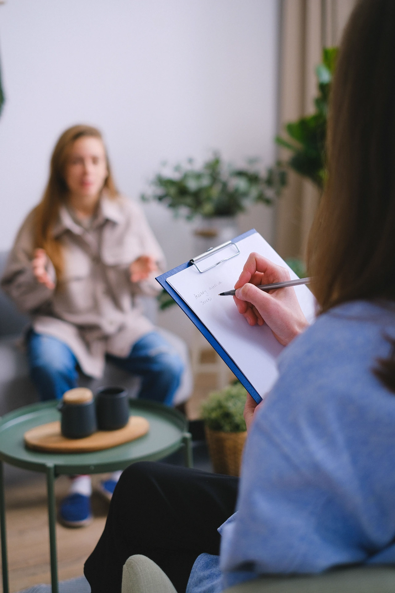 A therapist listening attentively to a client during a session