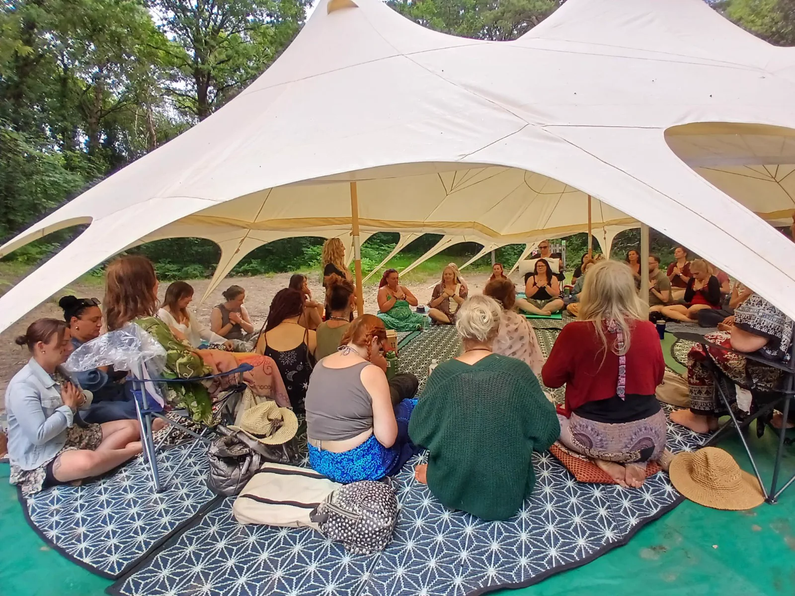 Samantha leading a group workshop in a woodland tent