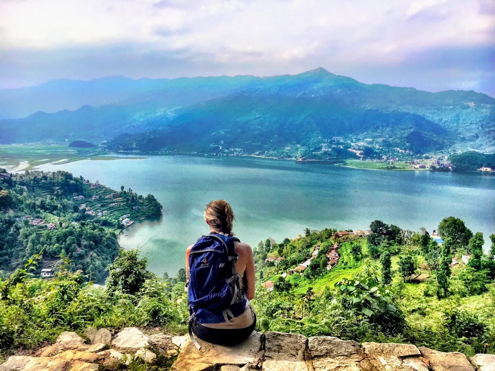 Samantha looking out over a lake in the mountains