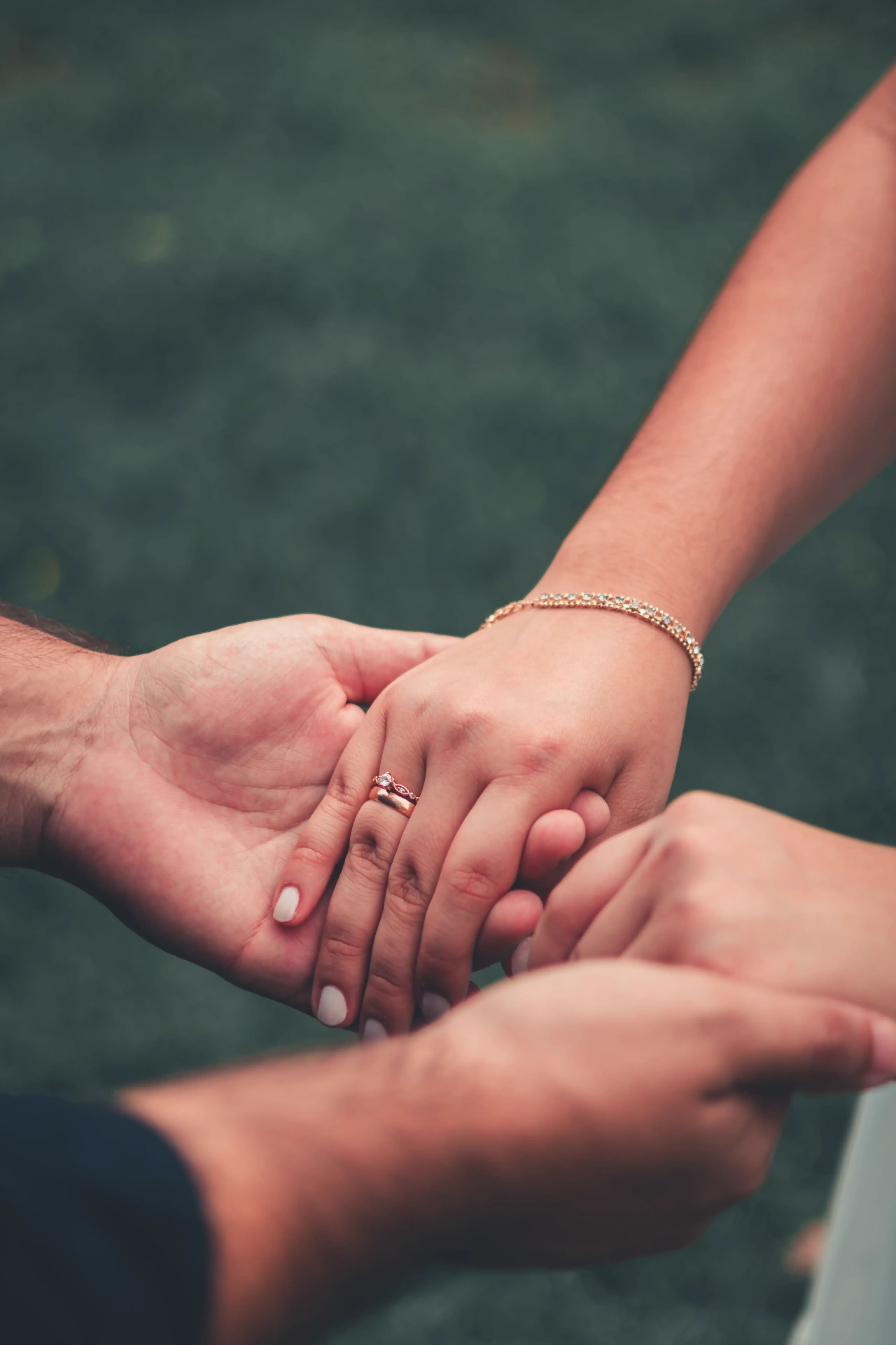 Two people gently holding hands — calming, supportive connection